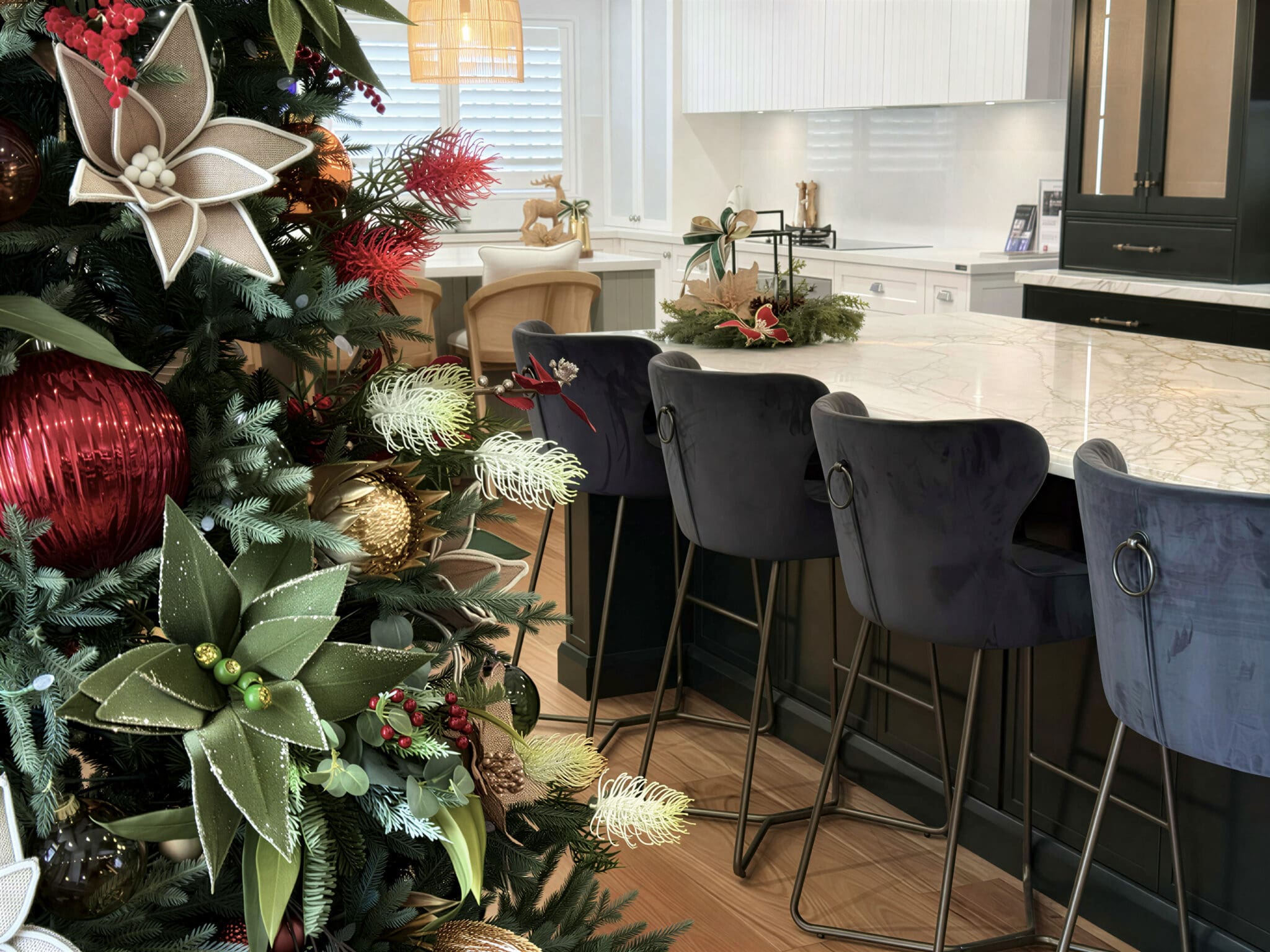 Harrington Kitchens showroom decorated for Christmas with a large native Christmas tree and styled kitchen island displays.