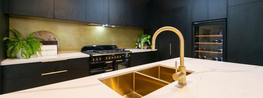 A modern kitchen with bold black accents, showcasing how black can be used in home decor without making the space feel dark or overpowering. The design features sleek black cabinetry and stylish fixtures, complemented by light countertops and natural lighting.