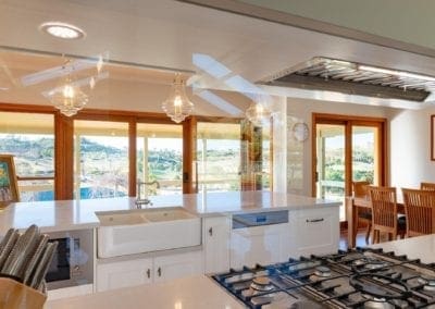 Classic mirrored Hamptons Douglas Park kitchen cook top view to balcony