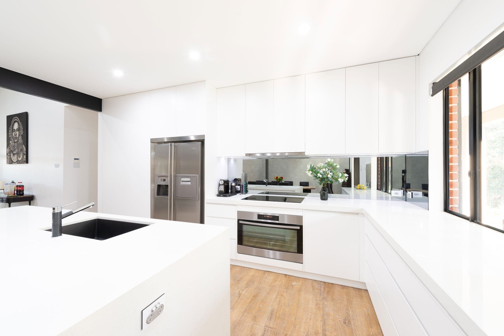 Modern white polyurethane kitchen Oakdale mirrored splashback oven cooktop