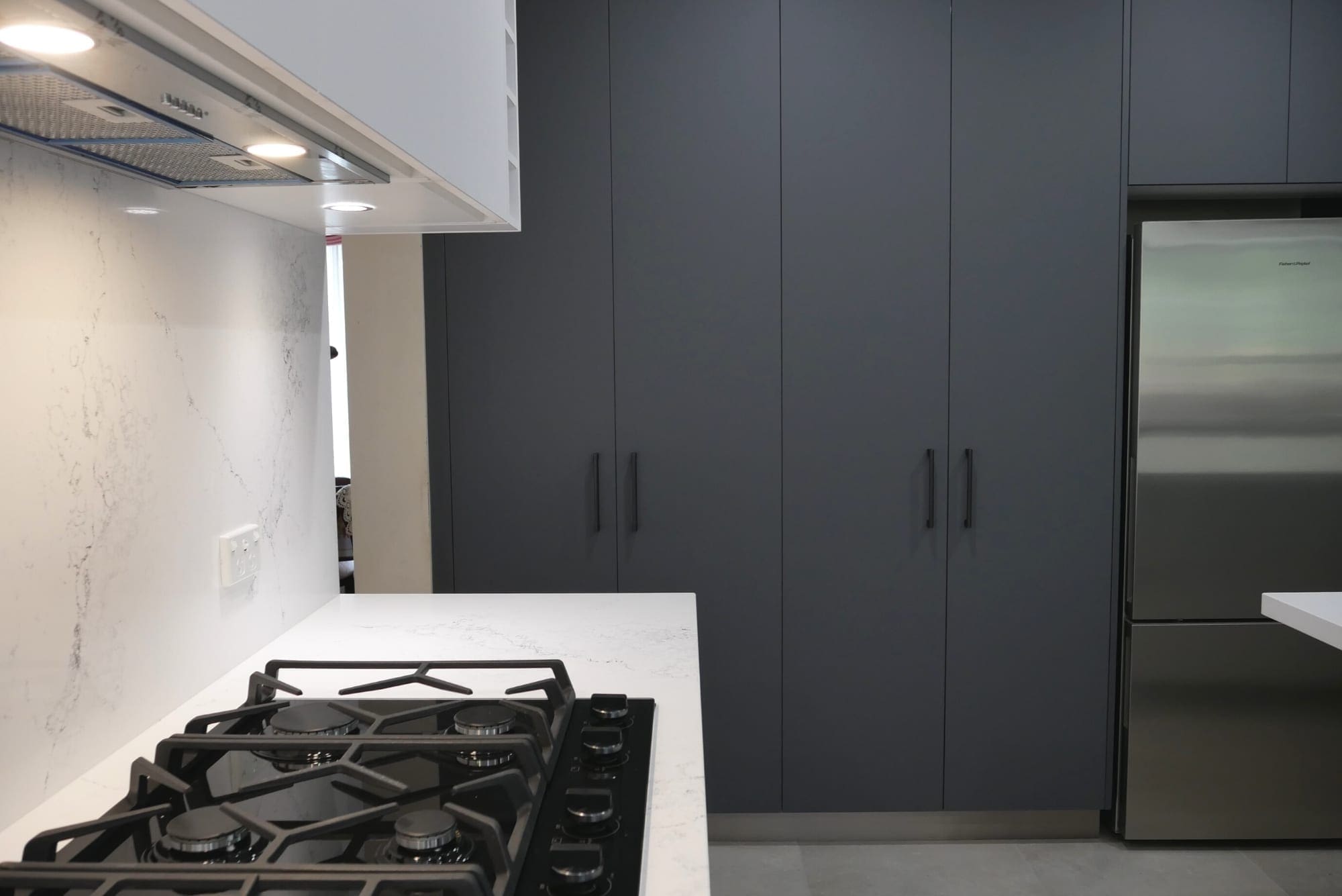 sleek black and white matte kitchen Harrington Park white cabinetry