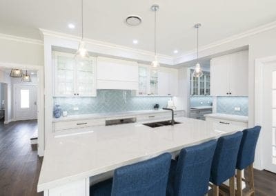 Modern contemporary kitchen with light blue hues wide shot with butlers pantry