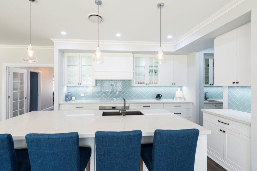 Modern contemporary kitchen with light blue hues wide shot with butlers pantry