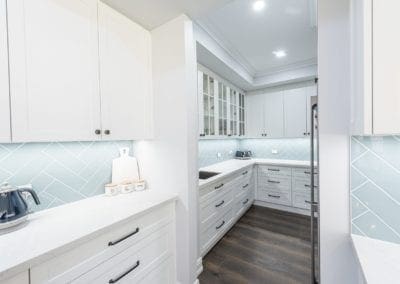 Modern contemporary kitchen with light blue hues butlers pantry