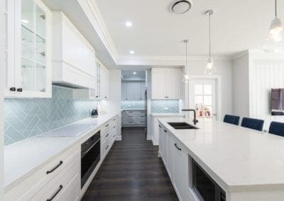 Modern contemporary kitchen with light blue hues wide shot with butlers pantry