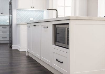 Modern contemporary kitchen with light blue hues kitchen island microwave