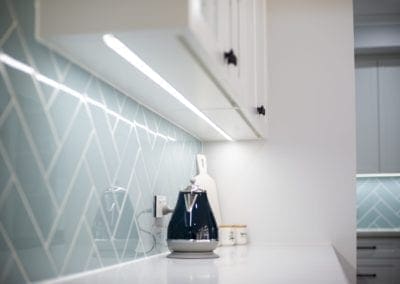 Modern contemporary kitchen with light blue hues LED strip under cabinetry