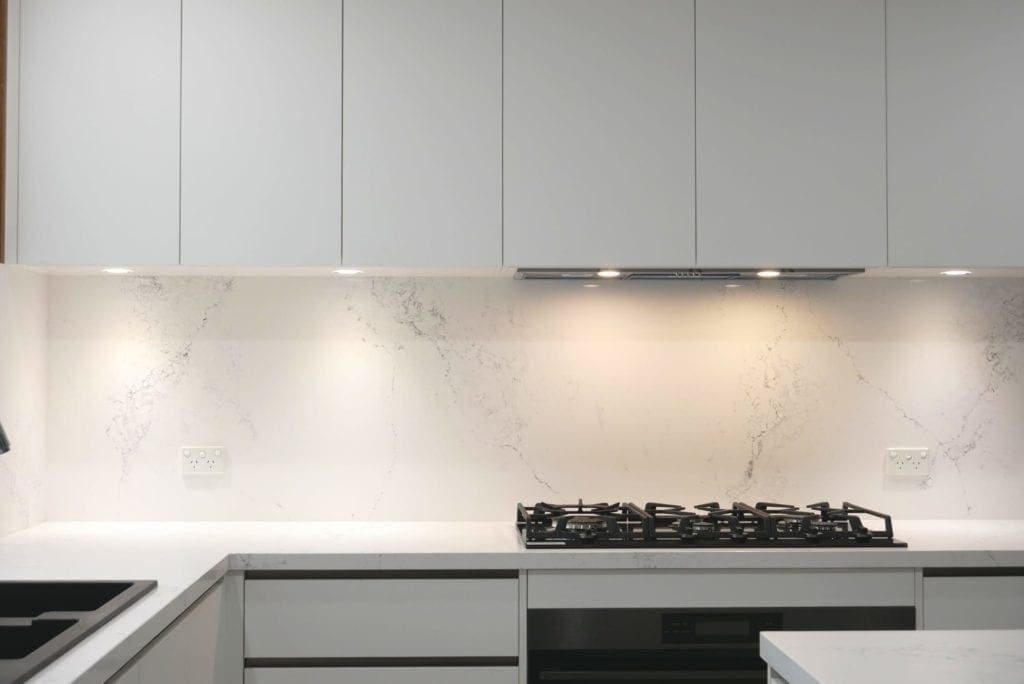 sleek black and white matte kitchen Harrington Park downlit splashback