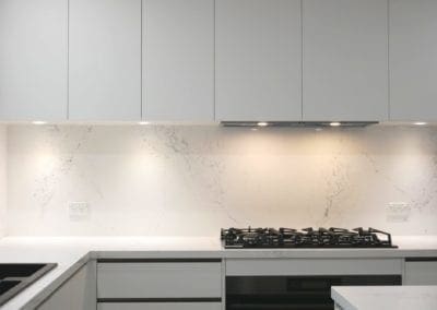 sleek black and white matte kitchen Harrington Park downlit splashback