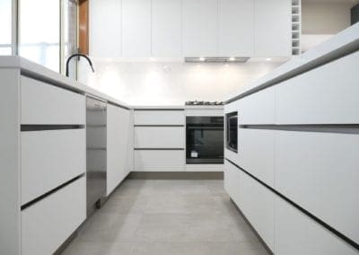 sleek black and white matte kitchen Harrington Park white cabinetry