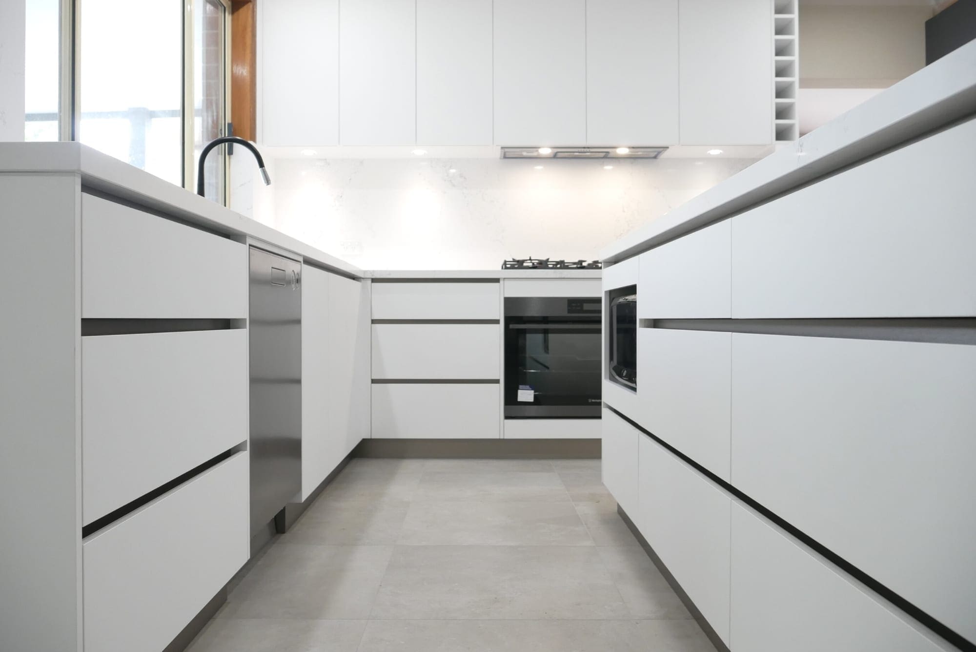 Sleek-black-and-white-matt-kitchen-fingerpull-white-cabinetry-Harrington-Park (1)