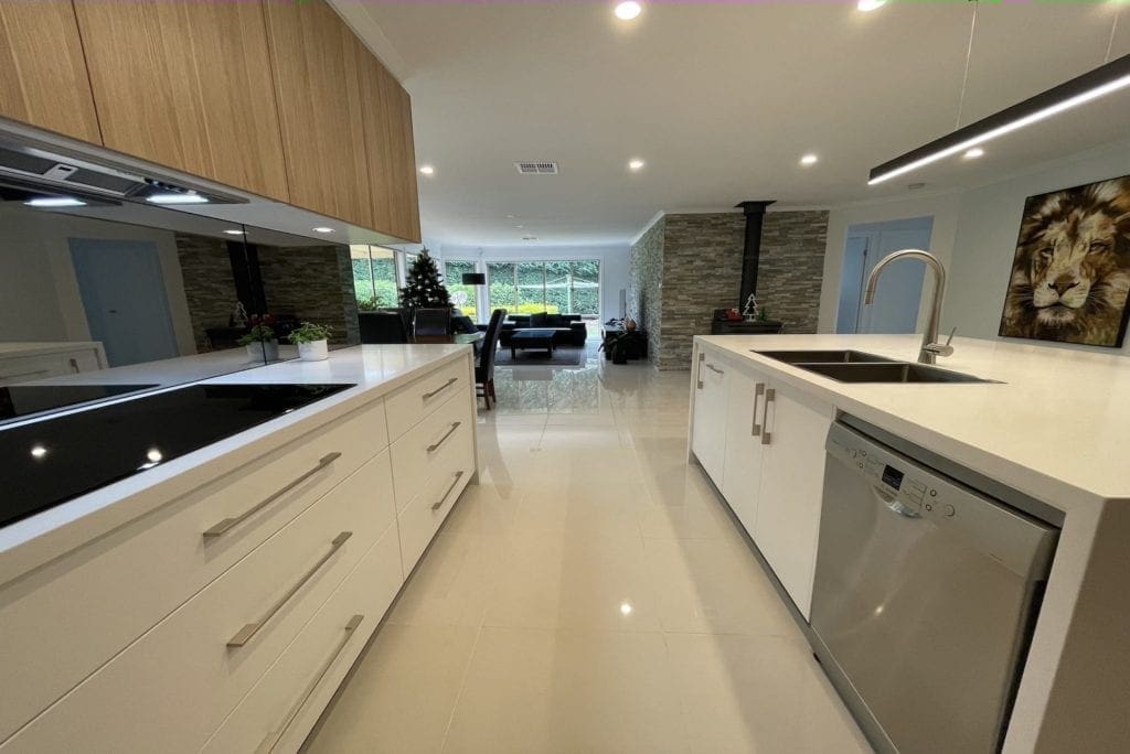 ultra modern two toned kitchen bargo mirrored splashback and upper wooden cabinetry