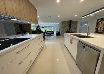 ultra modern two toned kitchen bargo mirrored splashback and upper wooden cabinetry