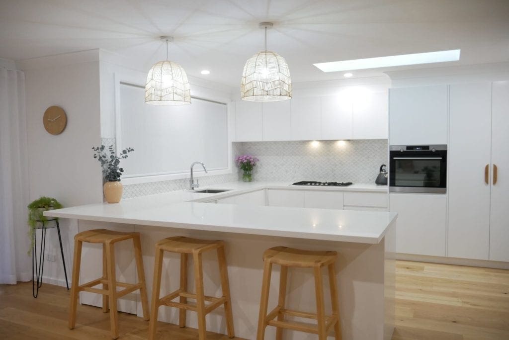 coastal feel white kitchen Narellan wooden barstools and hanging coastal light shades