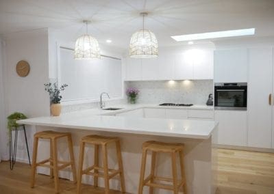 coastal feel white kitchen Narellan wooden barstools and hanging coastal light shades