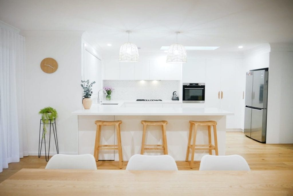 coastal feel white kitchen Narellan wooden barstools and hanging coastal light shades