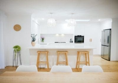 coastal feel white kitchen Narellan wooden barstools and hanging coastal light shades