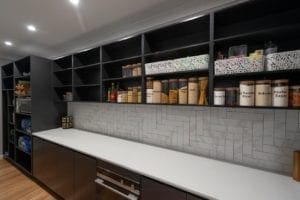 Large Butler's pantry with lots of open shelving and bench space