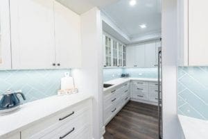 Modern contemporary kitchen with light blue hues butlers pantry