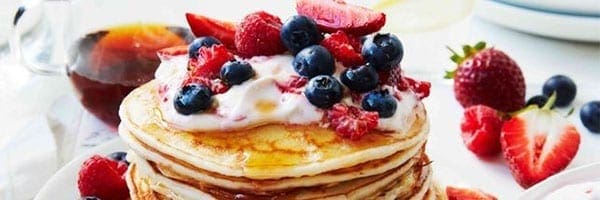 Coconut Pancakes with Berries and Syrup Drizzle