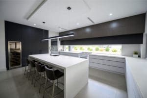sleek streamlined stunning two toned kitchen Kirkham wide shot with integrated wine fridge cabinetry