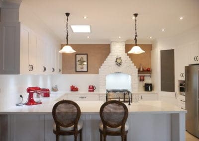 Character country filled kitchen in Mittagong white cabinetry with overhanging lights