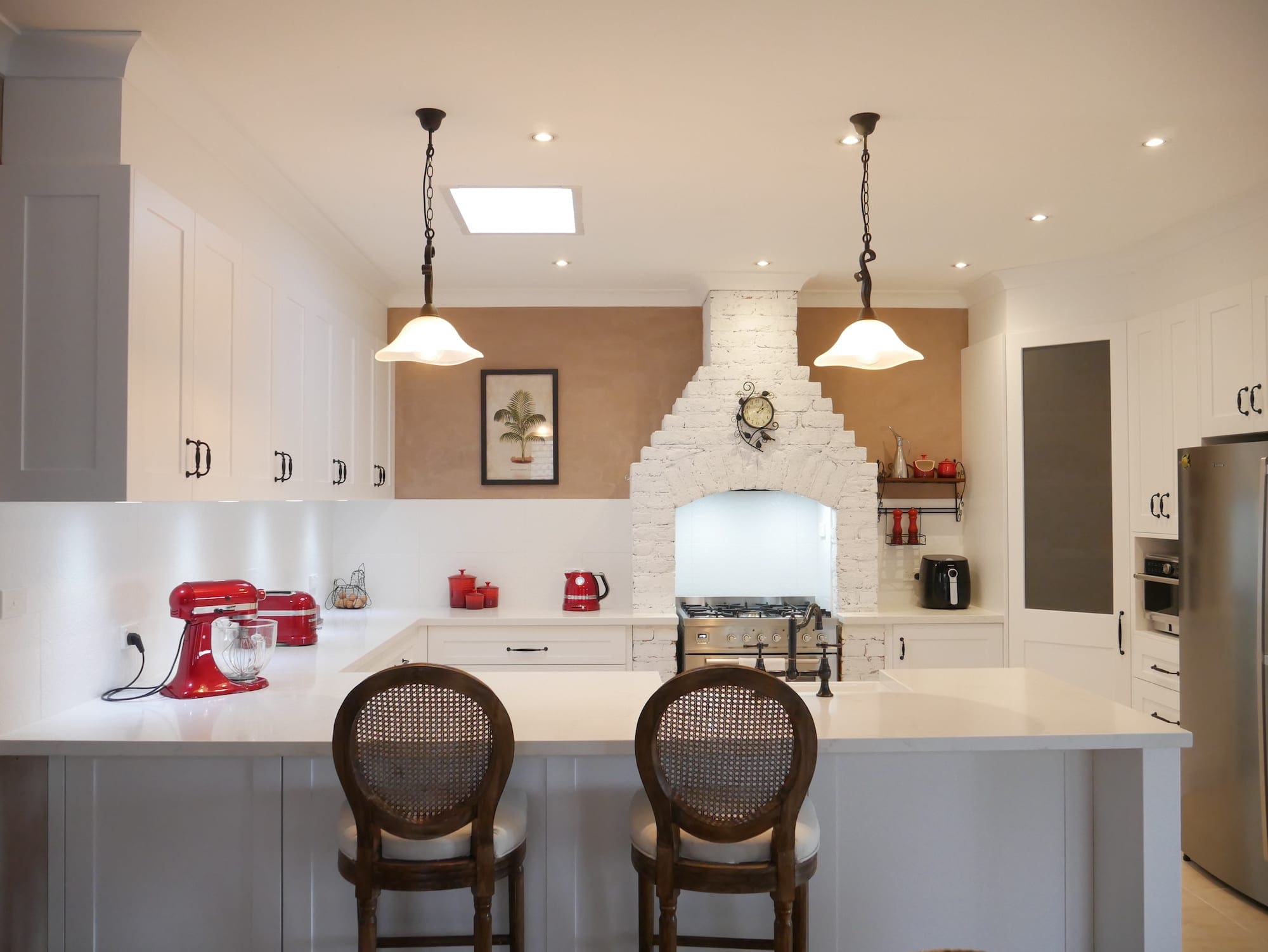 Character country filled kitchen in Mittagong white cabinetry with overhanging lights