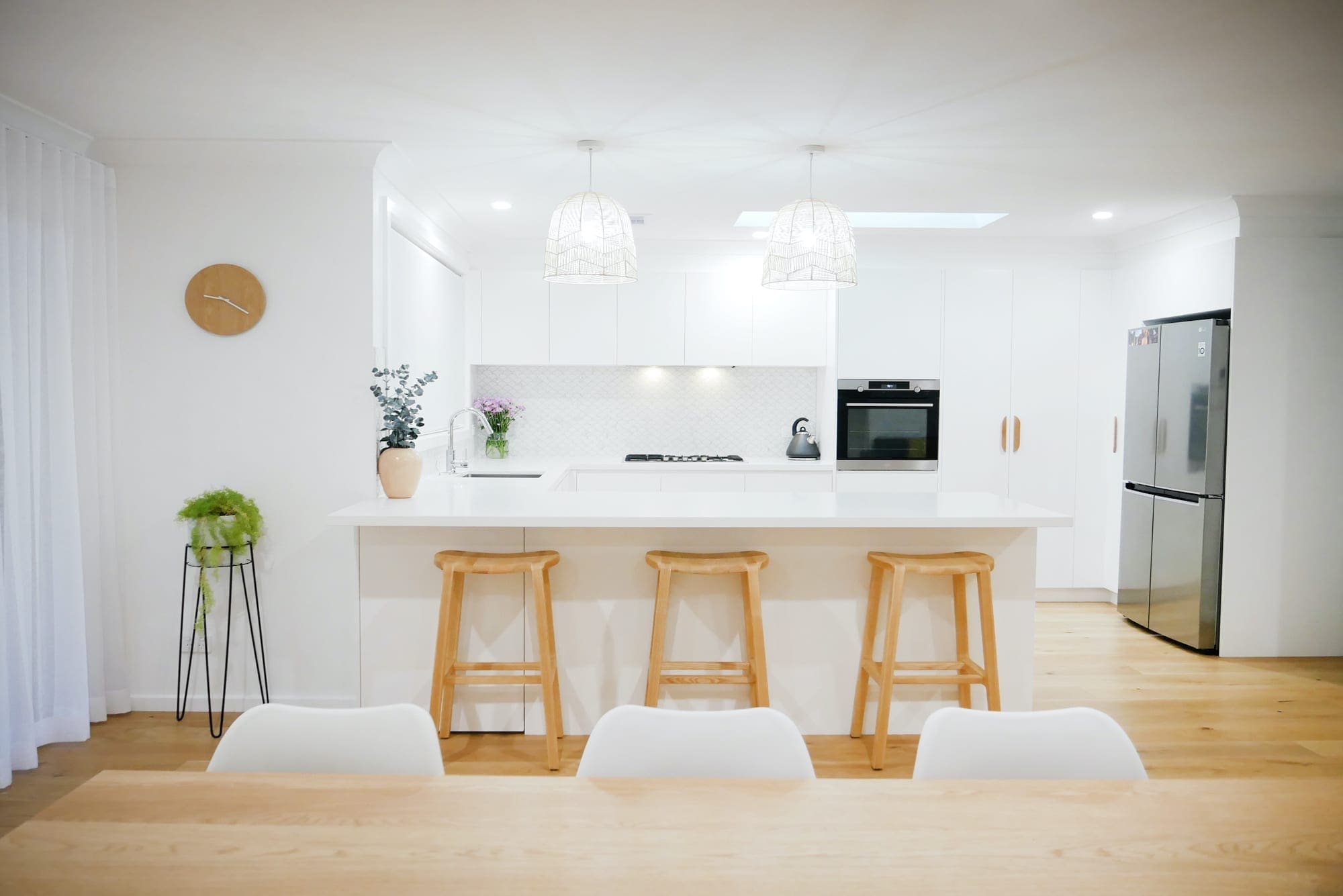 Character country filled kitchen in Mittagong white cabinetry with overhanging lights