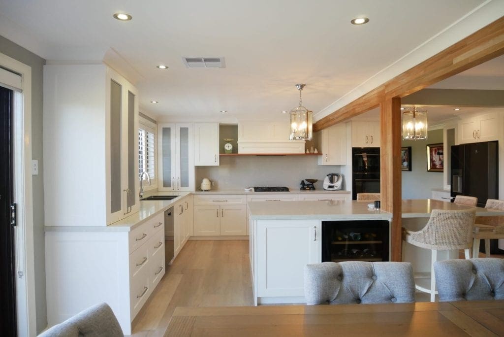 Contemporary Hamptons with timber highlights Barden Ridge with white cabinetry and wooden beam in the centre of the ceiling