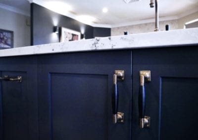 Dramatic two tones kitchen Bowral with brass handles and white marble stone