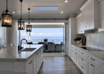 Luxury kitchen renovation in Wombarra, Sydney — modern ocean-inspired design with sweeping coastal views from the balcony.