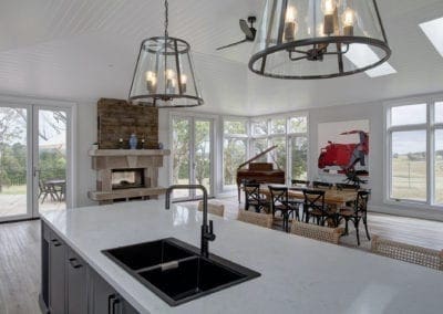 Stylish country hamptons style kitchen in moss vale dining area and fire place with black tapwear