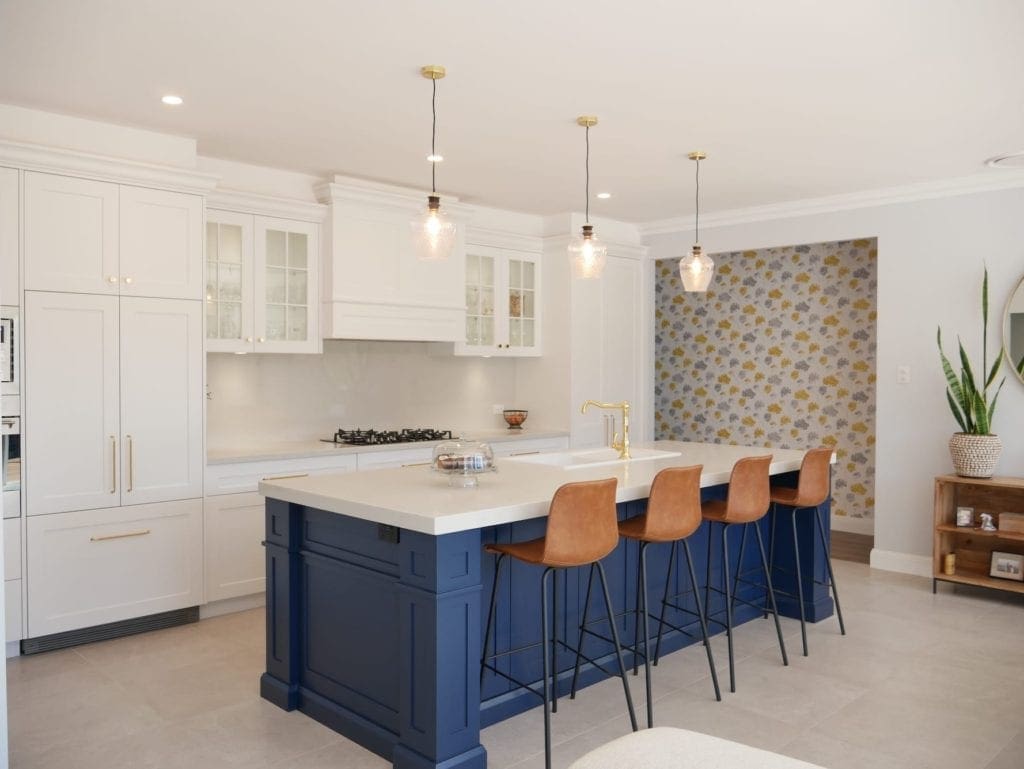 two toned easy living kitchen bowral wide shot with blue kitchen island and hanging light pendants