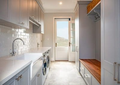 stunning modern open laundry mud room with grey cabinetry
