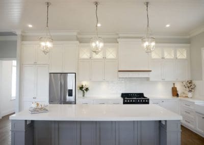 hamptons two toned kitchen front view with grey kitchen island and white cabinetry