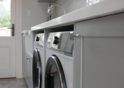 modern laundry close up of bench top stone and modern appliances