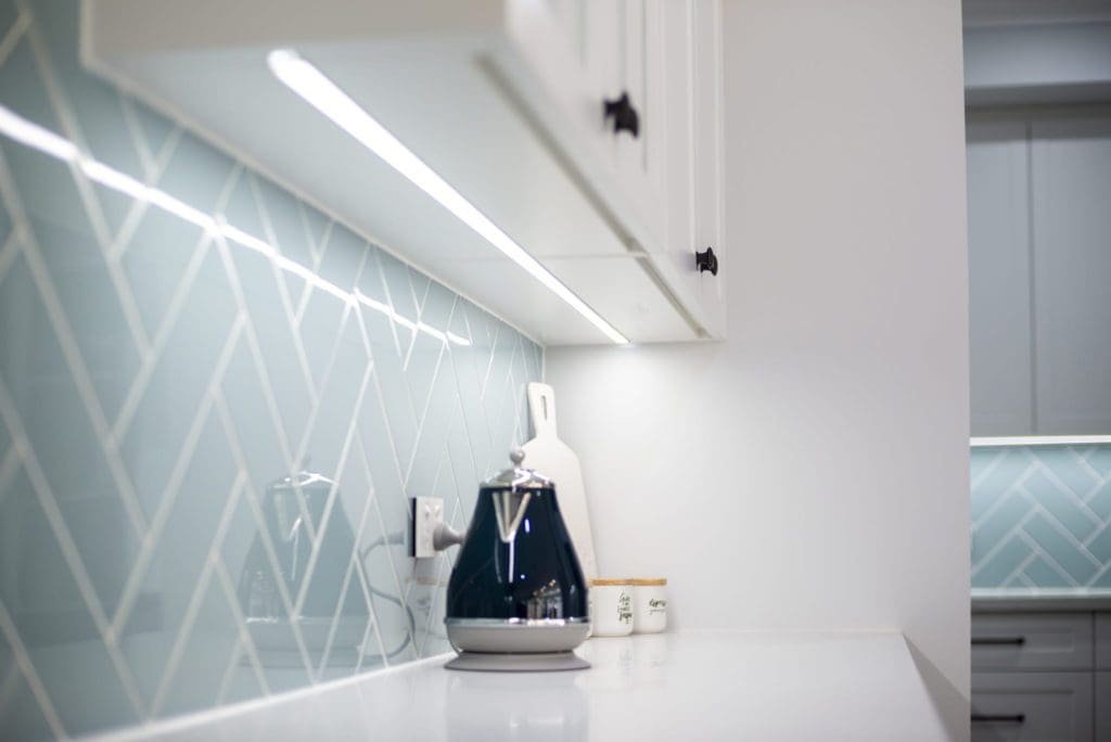 Modern contemporary kitchen with light blue hues LED strip under the cabinetry