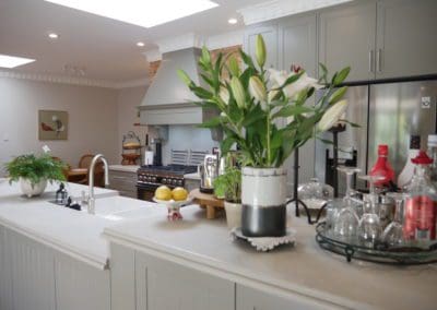 Stylish galley kitchen burradoo stepped island and green plants
