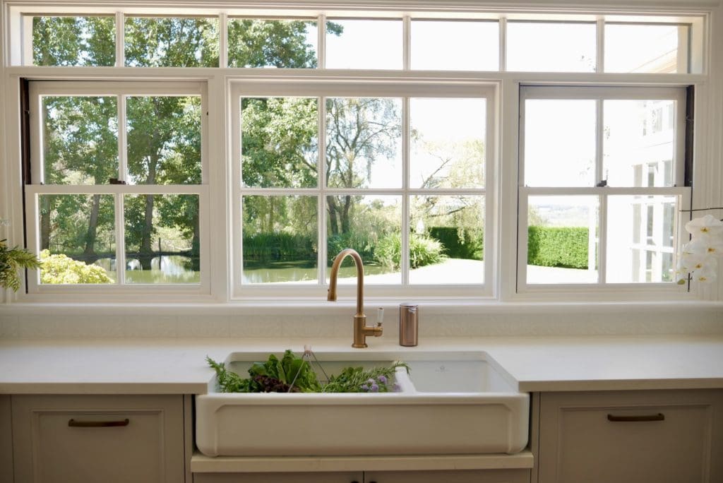 Travers stylish tranquil kitchen Manchester Square kitchen sink with brass tap and garden view window