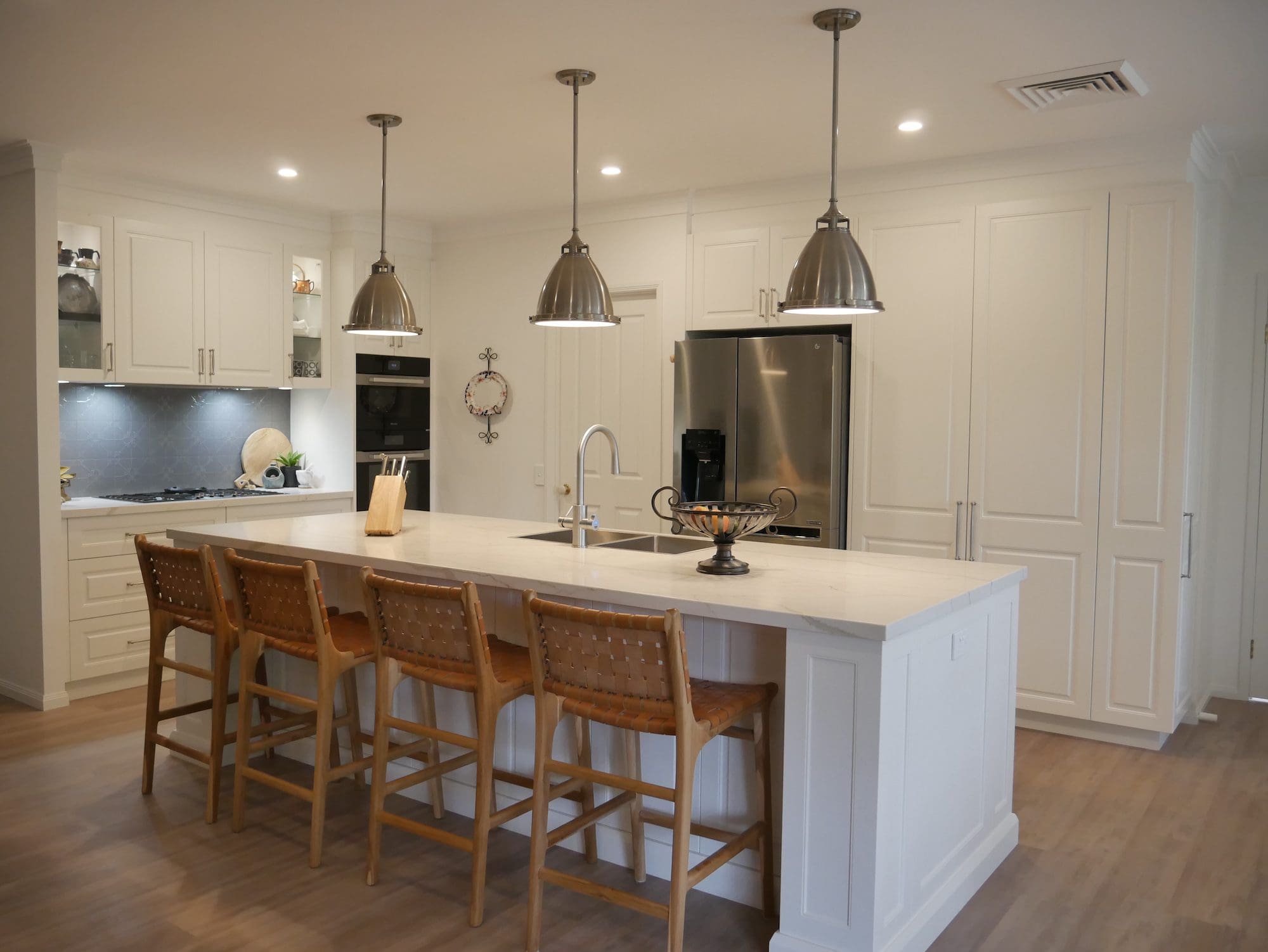 Stilish-galley-kitchen-wide-view classic warm white kitchen Burradoo kitchen island and hanging pendants
