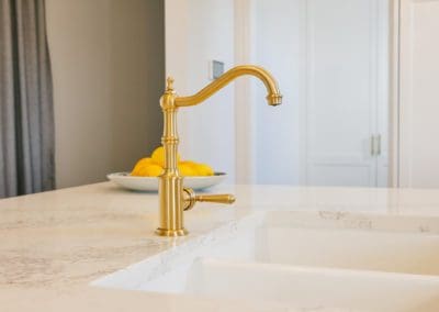 glamorous and bold two toned hamptons kitchen shell cove gold mixer tap