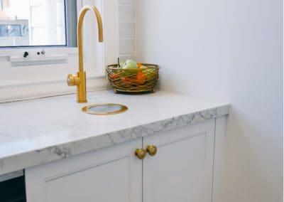 glamorous and bold two toned hamptons kitchen shell cove gold zip tap
