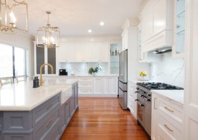 Elegant refined two toned kitchen Harrington Park hanging light pendants kitchen island