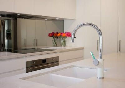 Stylish-mirrored-modern-kitchen-Burradoo-white-kitchen-bench-silver-tap