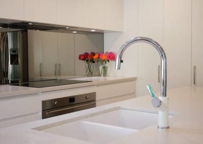 Stylish-mirrored-modern-kitchen-Burradoo-white-kitchen-bench-silver-tap