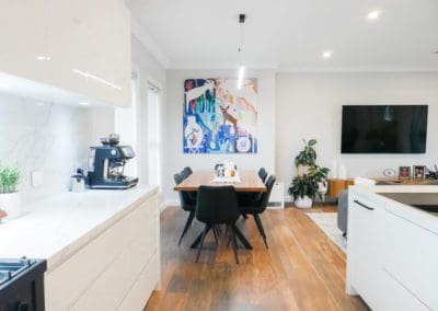 streamlined sophisticated kitchen mount annan lounge room and colourful artwork on wall