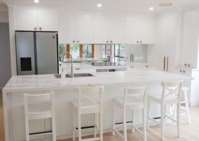 simple stylish white kitchen bowral mirror splashback wide kitchen island