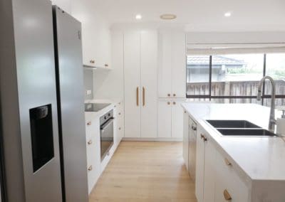 simple stylish white kitchen bowral sink and wooden handle cabinetry