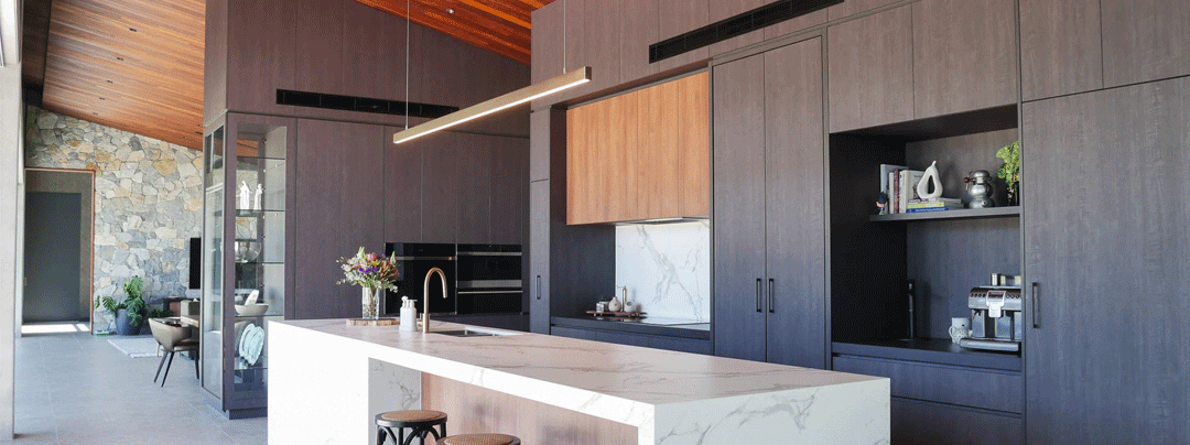Stunning and impressive main kitchen design in Cobbity, featuring sustainable and resilient Navurban, a cost-effective timber alternative. The dark, moody Ashgrove and the deep warmth of Boxwood create truly impressive living areas.