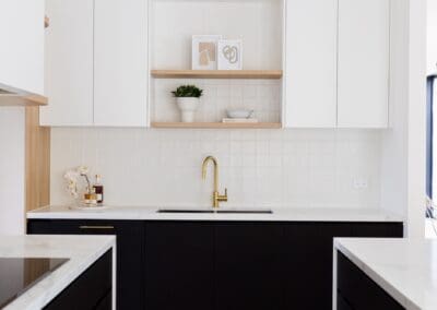 In the butler's pantry, brushed brass features are incorporated into the tapware, including the ABI Interiors Elysian Commercial Pull-out Mixers.